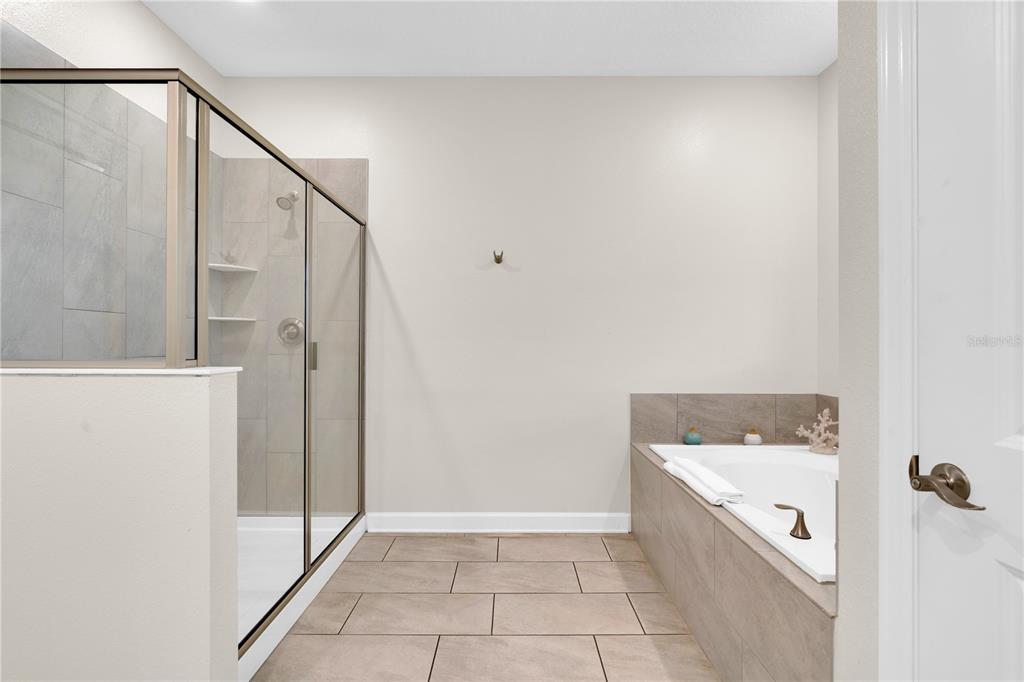 4530 Narrative Lane Kissimmee, FL 34746 - Photo 33 of 98 a bathroom with a bathtub and shower