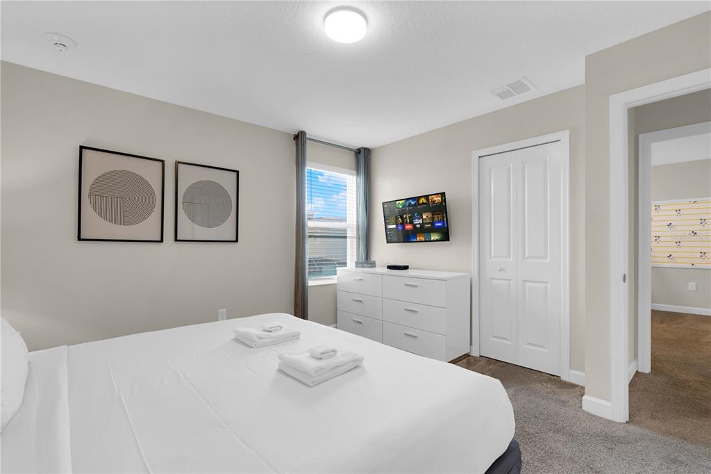 4530 Narrative Lane Kissimmee, FL 34746 - Photo 37 of 98 a bedroom with a bed and a dresser