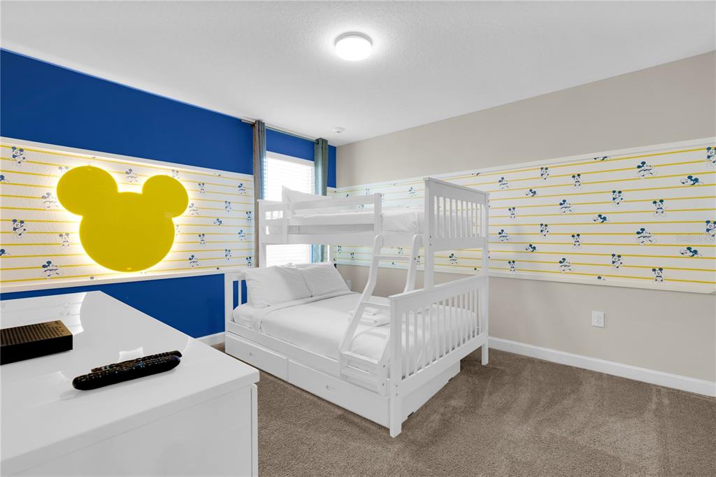 4530 Narrative Lane Kissimmee, FL 34746 - Photo 38 of 98 a bedroom with a bed and a mirror