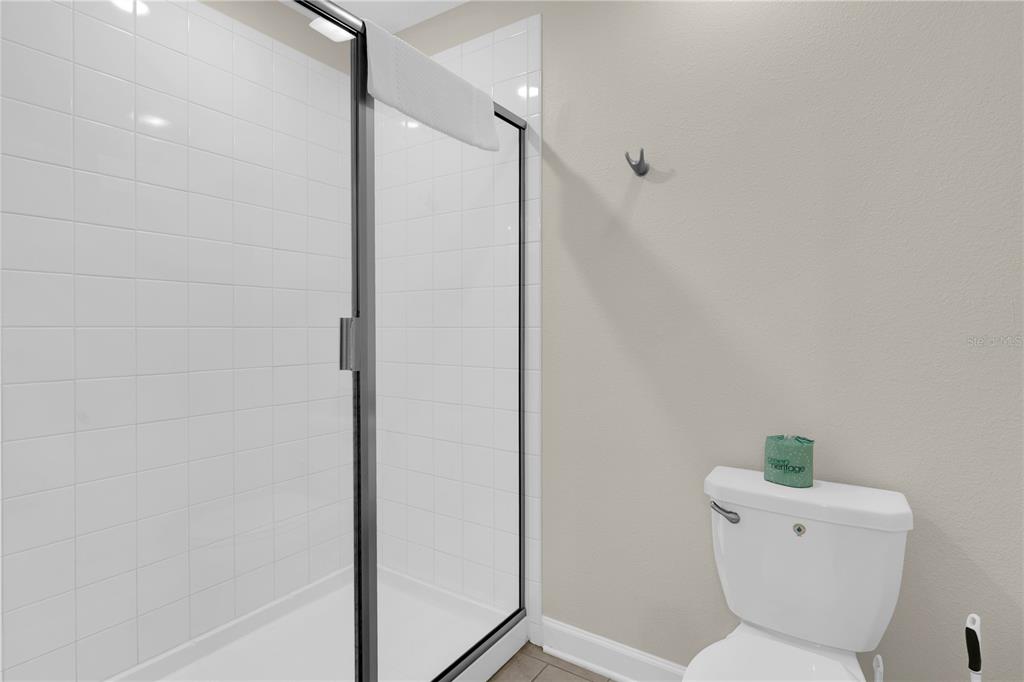 4530 Narrative Lane Kissimmee, FL 34746 - Photo 41 of 98 a bathroom with a toilet and a shower