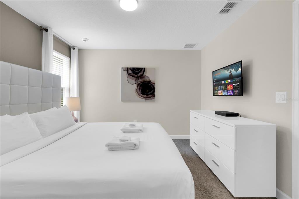 4530 Narrative Lane Kissimmee, FL 34746 - Photo 42 of 98 a bedroom with a bed and a flat screen tv