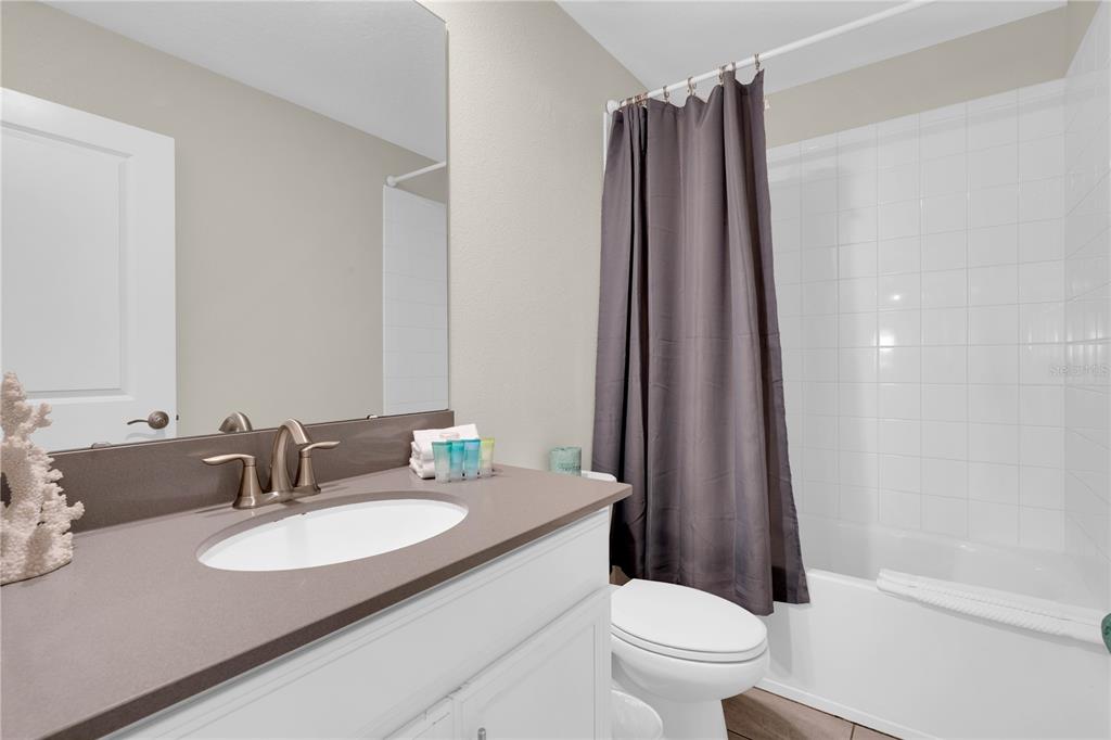 4530 Narrative Lane Kissimmee, FL 34746 - Photo 48 of 98 a bathroom with a sink toilet and shower