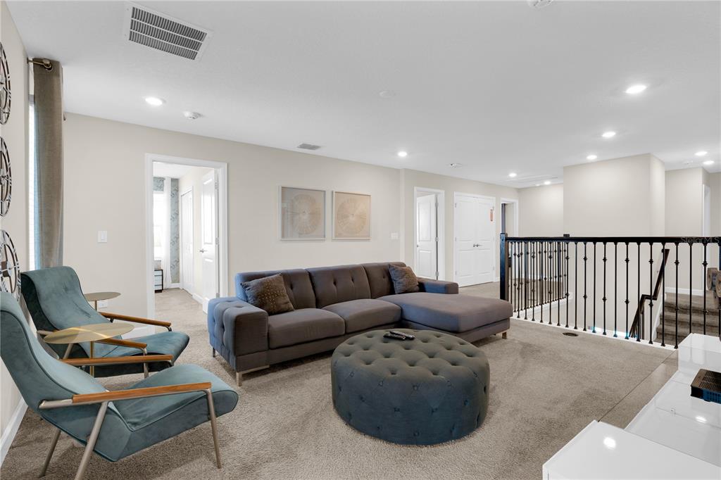 4530 Narrative Lane Kissimmee, FL 34746 - Photo 53 of 98 a living room with furniture and a wooden floor