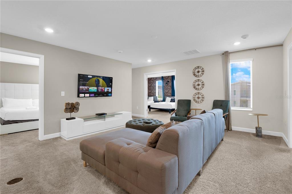 4530 Narrative Lane Kissimmee, FL 34746 - Photo 55 of 98 a living room with furniture and a flat screen tv