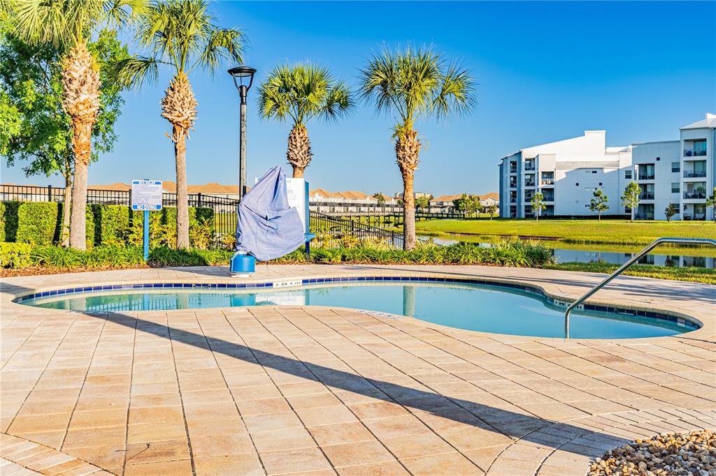 4530 Narrative Lane Kissimmee, FL 34746 - Photo 79 of 98 a view of swimming pool with outdoor seating and a tree