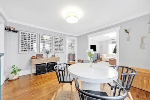 a view of a dining room with furniture and window