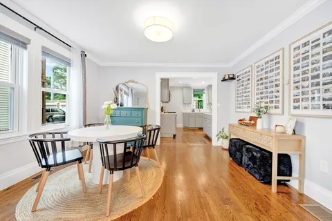 a dining room with furniture and wooden floor