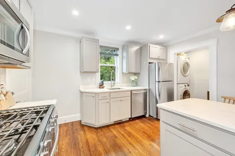 a kitchen with a refrigerator and a sink