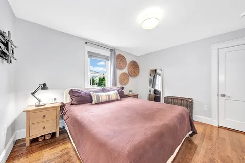 a bedroom with two beds and a dresser