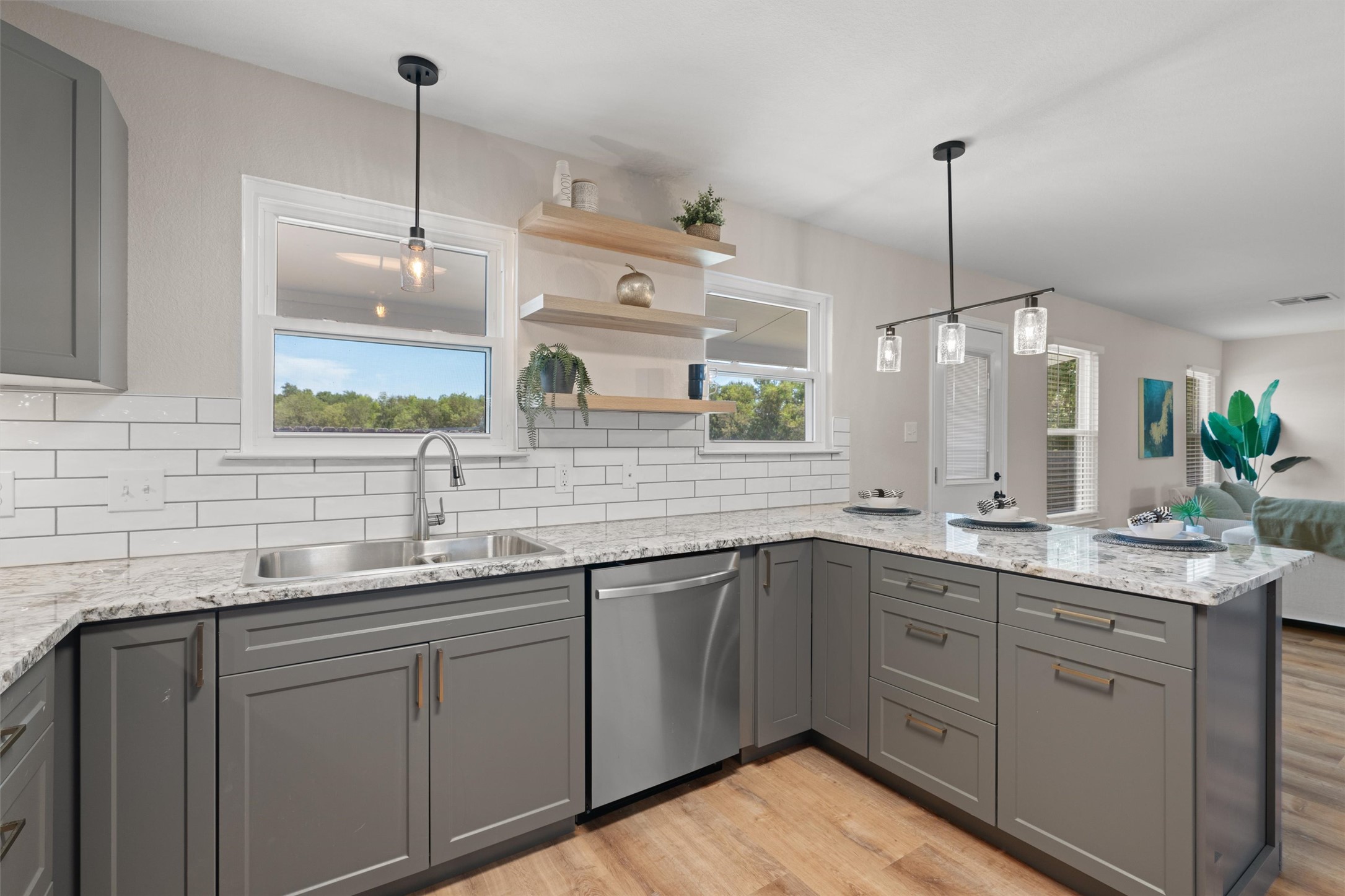 724 Lavaca Loop Elgin, TX 78621 - Photo 13 of 40 Granite countertops and subway tile backsplashes accent this modern kitchen workspace.
