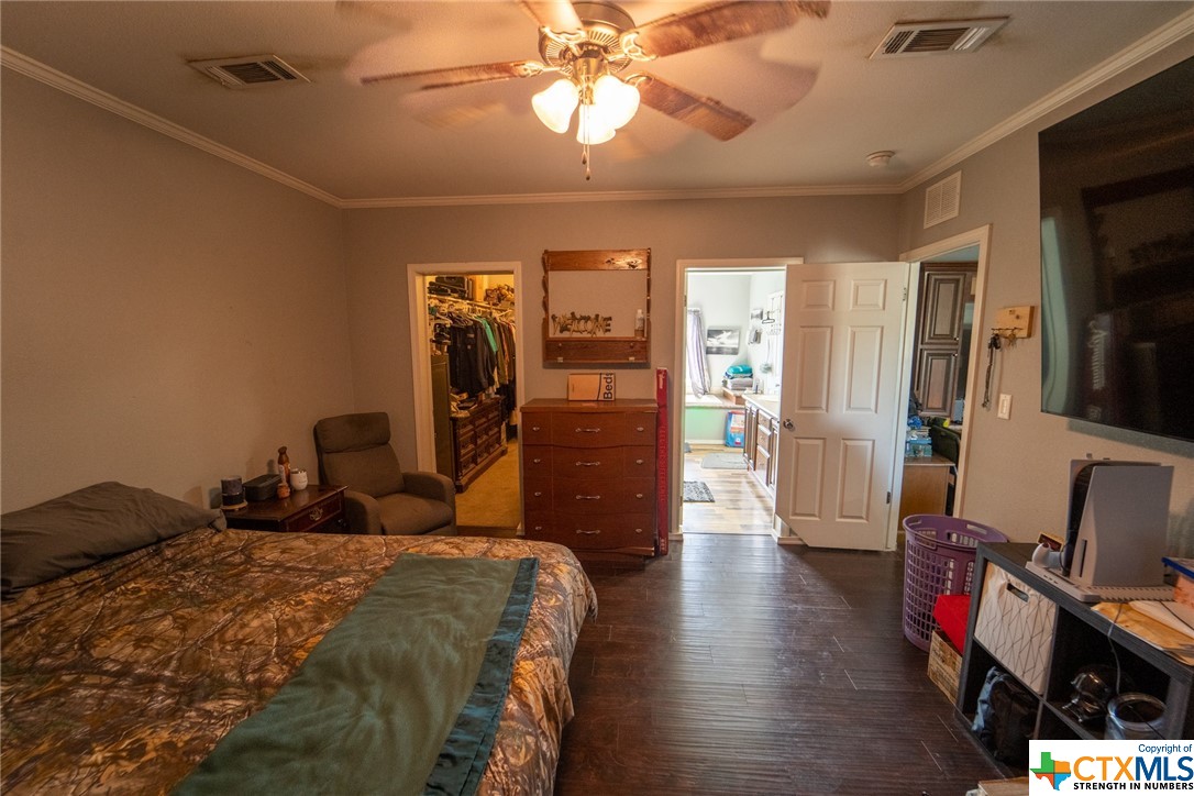 443 Joe Pokluda Road Nordheim, TX 78141 - Photo 12 of 26 a bedroom with a bed and wooden floor