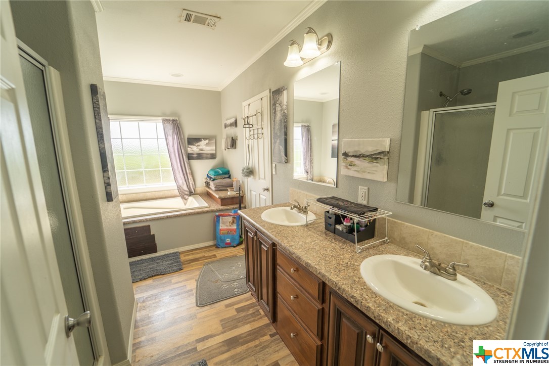 443 Joe Pokluda Road Nordheim, TX 78141 - Photo 13 of 26 a bathroom with a granite countertop sink and a mirror