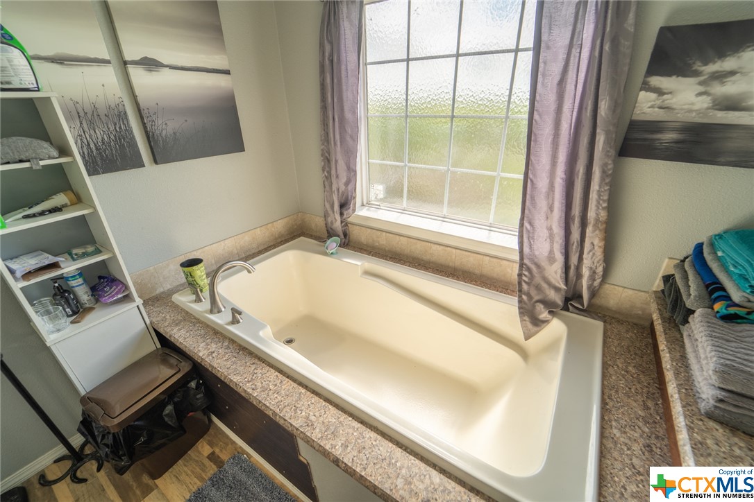 443 Joe Pokluda Road Nordheim, TX 78141 - Photo 14 of 26 a bathroom with a tub and a window