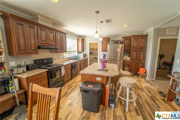 a open kitchen with stainless steel appliances granite countertop a lot of counter space and a sink