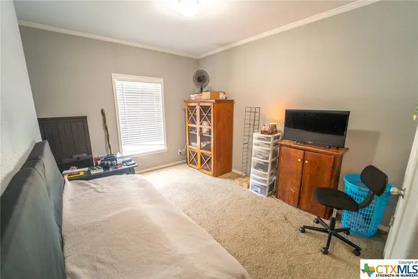 a bedroom with a bed and a chair in it