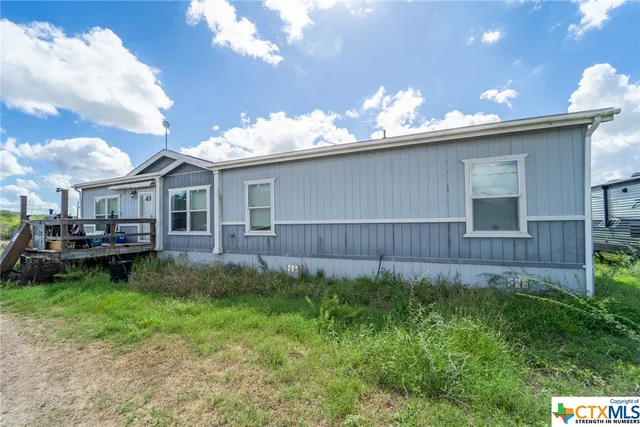 a view of a house with a back yard