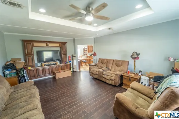 a living room with furniture and a wooden floor