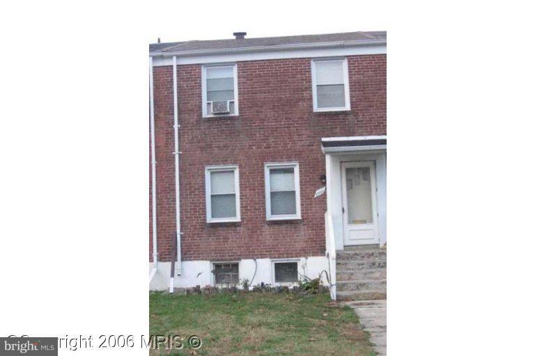 2906 Cornwall Road Dundalk, MD 21222 - Photo 1 of 5 a view of a brick house with a yard