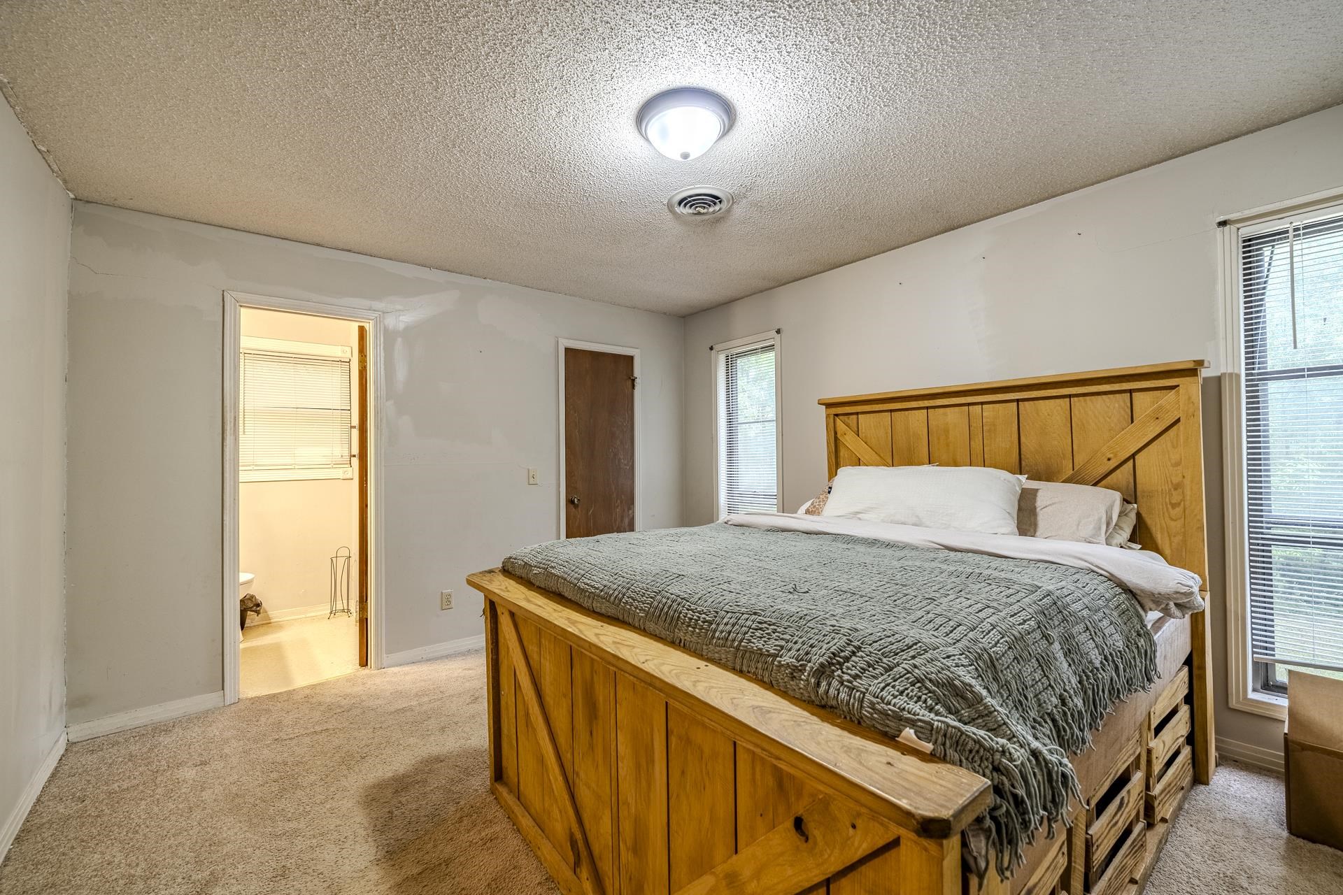 259 Oakview Drive Adamsville, TN 38310 - Photo 13 of 32 Carpeted room with light-colored walls and a textured ceiling