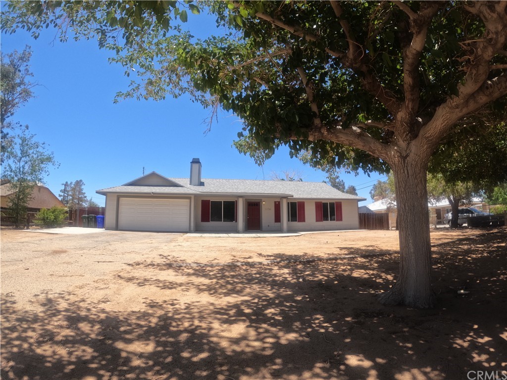 11736 Jamacha Road Apple Valley, CA 92308 - Photo 1 of 1 a front view of a house with a yard