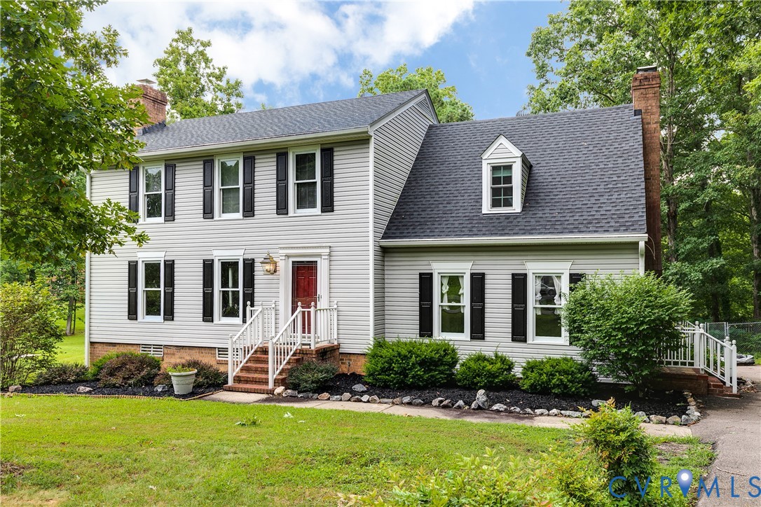 Two-story residence featuring light gray siding, a