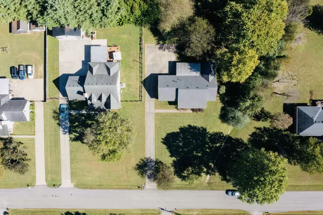 aerial view of a house with a yard and garden