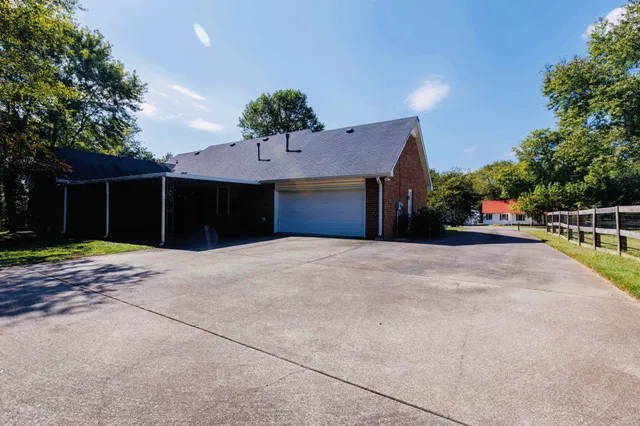 a front view of a house with a yard and a garage