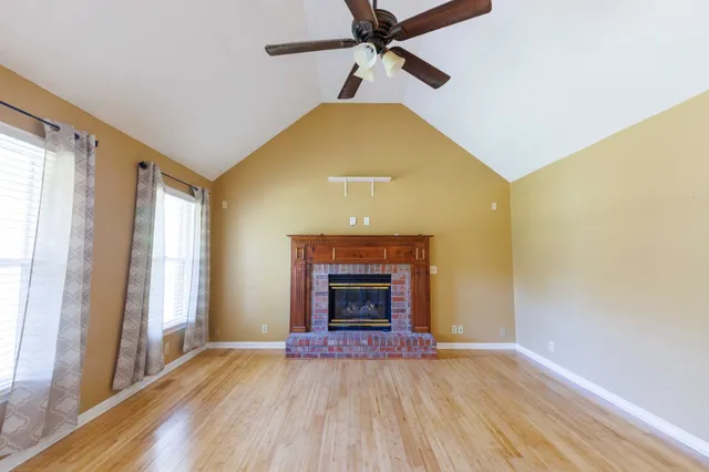 a view of a livingroom with a fireplace and window