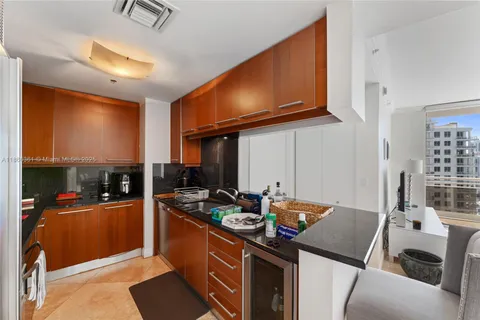 a kitchen with sink refrigerator and stove