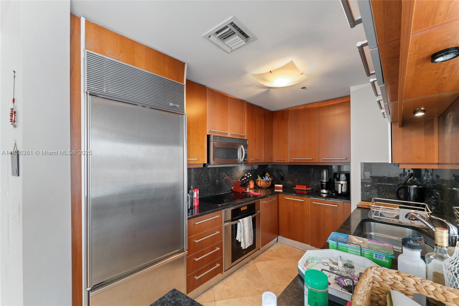 901 Brickell Key Boulevard, Unit 2801 Miami, FL 33131 - Photo 17 of 22 a kitchen with sink refrigerator and stove