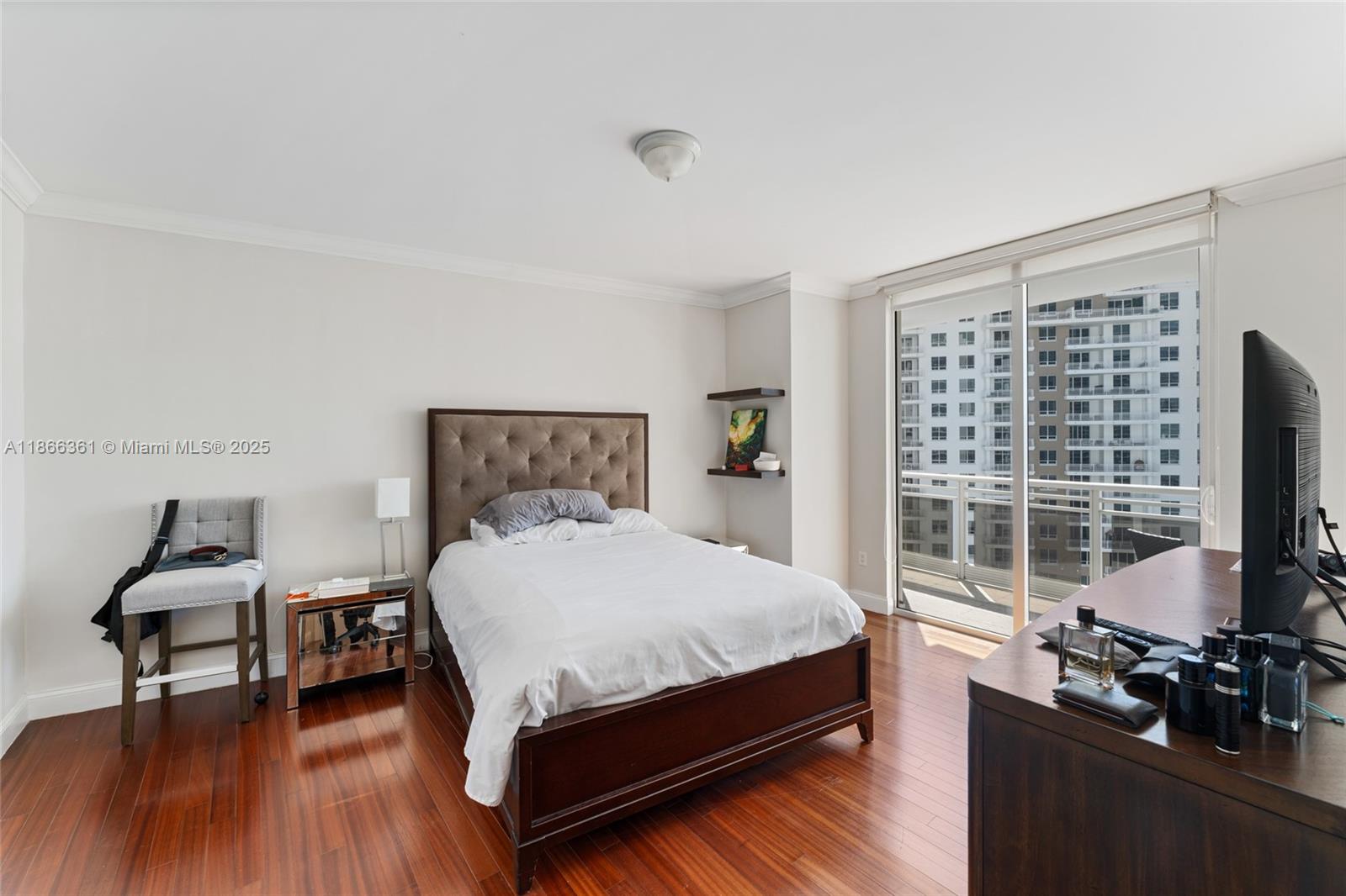 901 Brickell Key Boulevard, Unit 2801 Miami, FL 33131 - Photo 19 of 22 a bedroom with a bed and wooden floor