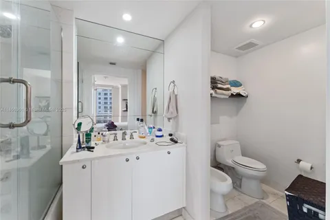 a bathroom with a double vanity sink mirror and shower