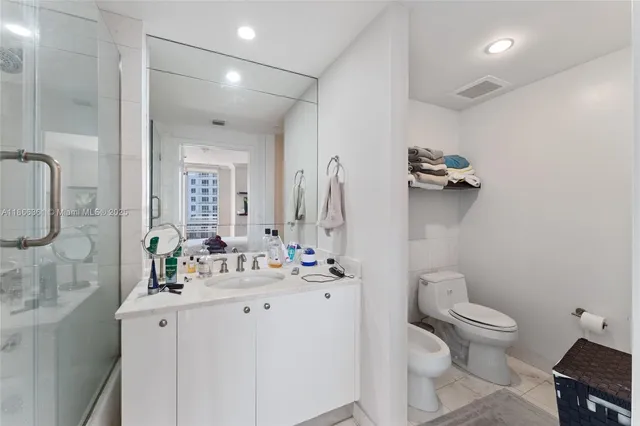 a bathroom with a double vanity sink mirror and shower
