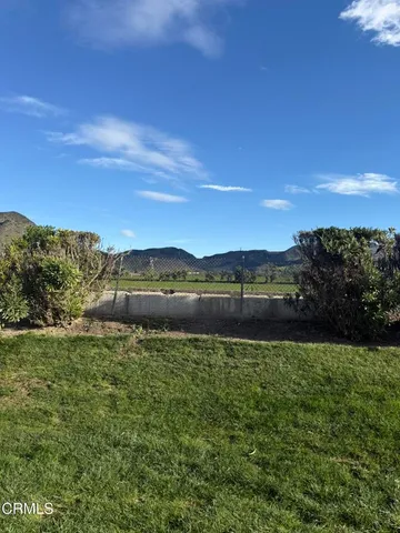 a view of a field with an ocean