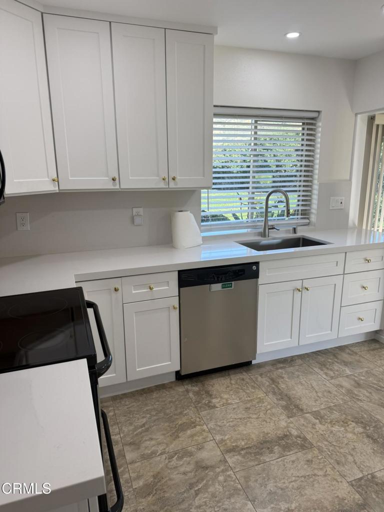 20178 Village 20 Camarillo, CA 93012 - Photo 5 of 19 a kitchen with granite countertop a sink a stove and cabinets