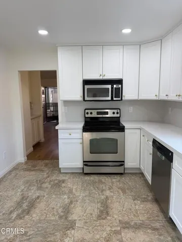 a kitchen with a stove oven and a refrigerator