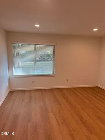 a view of a room with wooden floor
