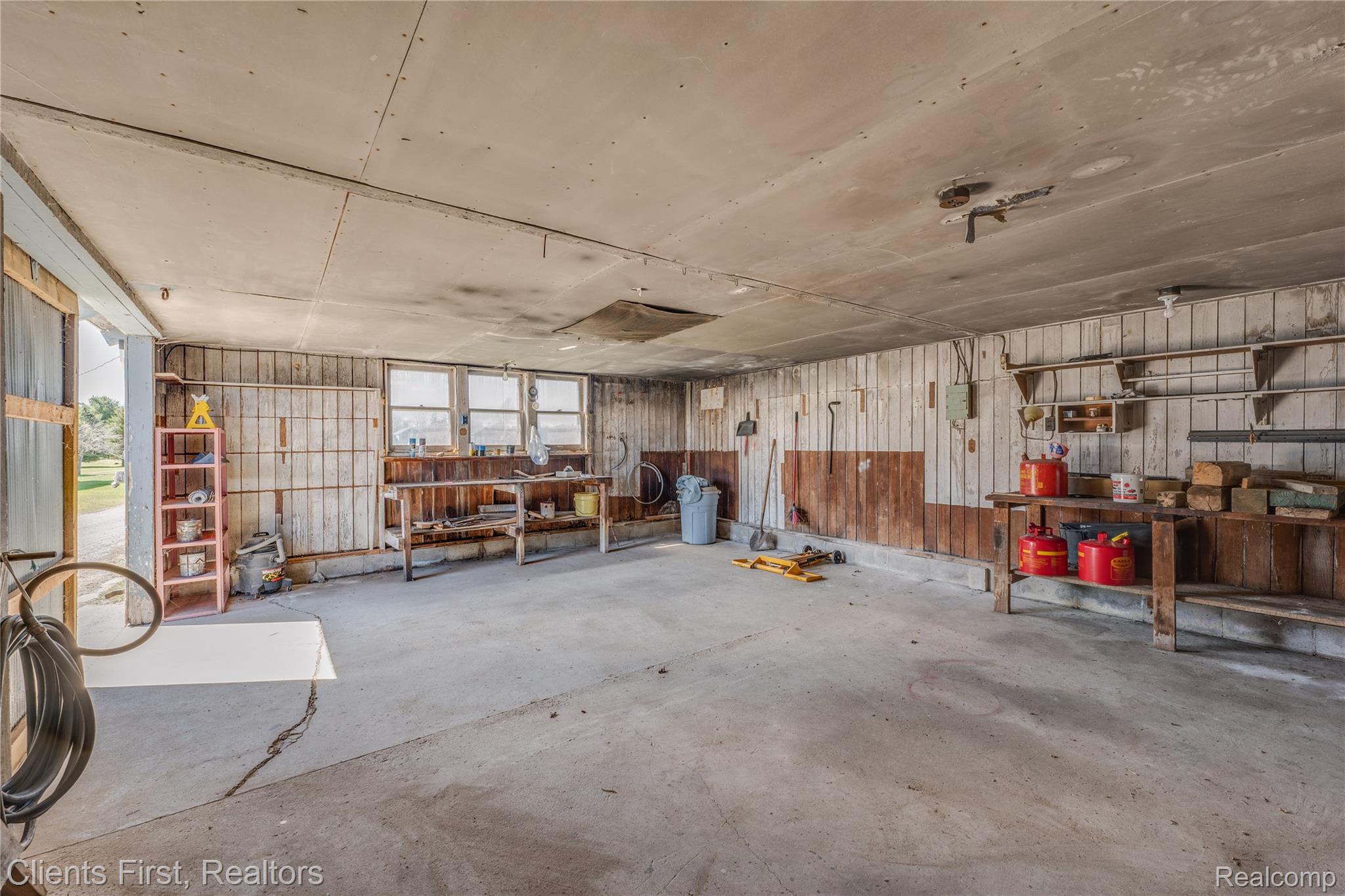 342 North Chambers Road Tawas City, MI 48763 - Photo 25 of 30 Miscellaneous room featuring unfinished concrete floors and a garage