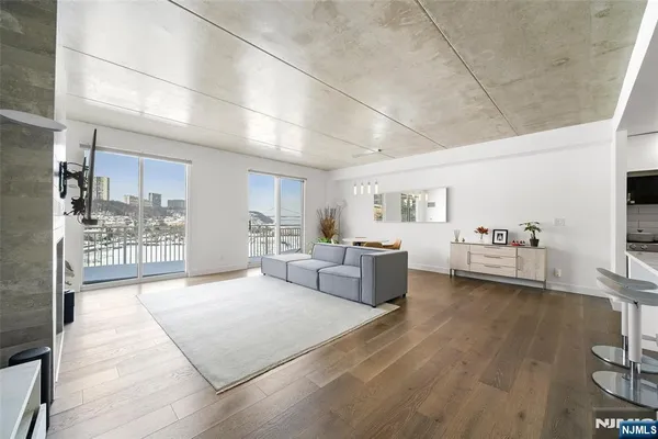 a living room with furniture and view of kitchen