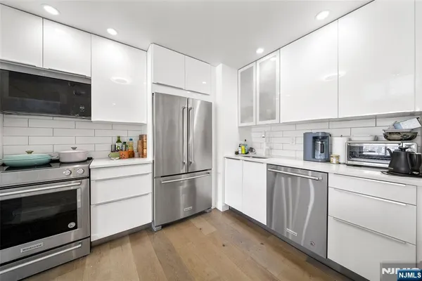 a kitchen with a refrigerator stove and microwave