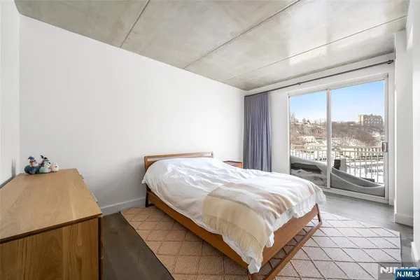 a bedroom with a bed and a large window