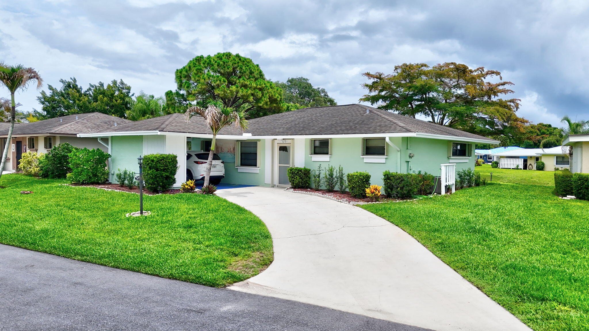 5251 Southeast Sea Island Way Stuart, FL 34997 - Photo 67 of 68 a view of a house with a yard and potted plants