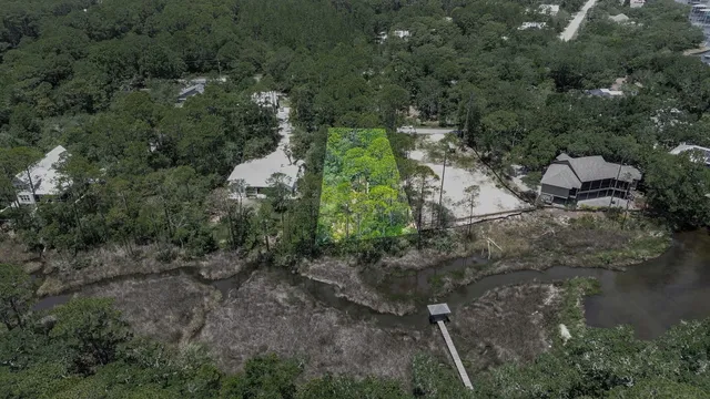 an aerial view of residential house with outdoor space and trees all around