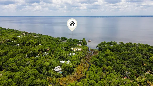 an aerial view of a house with a yard