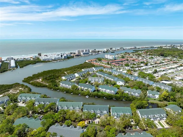 an aerial view of a city with lots of residential buildings lake and ocean view