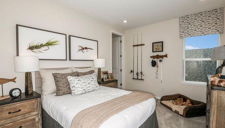 621 Se Ranch Palm City, FL 34990 - Photo 16 of 33 a bedroom with a bed and a painting on the wall