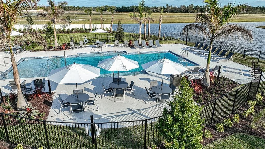 621 Se Ranch Palm City, FL 34990 - Photo 25 of 33 a view of a chairs and table in patio with a lake view