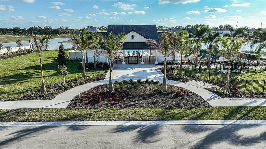 621 Se Ranch Palm City, FL 34990 - Photo 26 of 33 a front view of a house with a yard and lake view