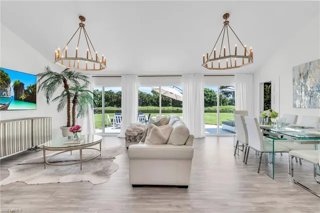 a living room with furniture a window and a chandelier