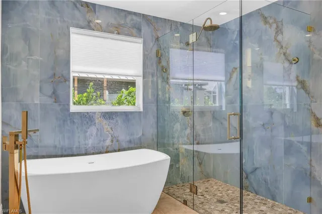 a bathroom with a bathtub and a shower